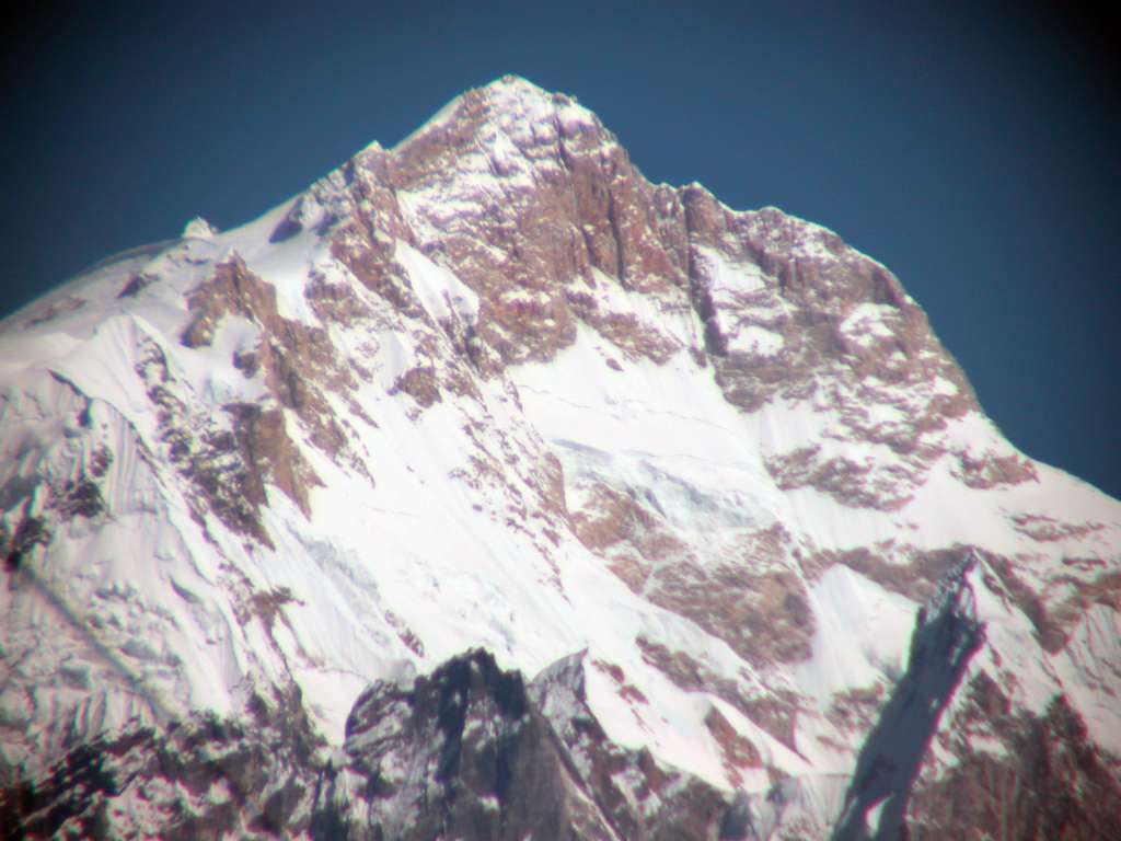 Annapurna 11 04 Manaslu Southwest Face Close Up From Chame From Chame, the magnificent Southwest face of Manaslu is perfectly visible. This face was first climbed by Reinhold Messner on April 25, 1972. After he reached the summit, a fierce storm came up and he had to fight for his life to reach their high camp. Franz Jager, who turned back, was caught out in the storm and died. Andi Schlick and Horst Fankhausen braved the storm to try and find Franz, but Andi got lost and also died.